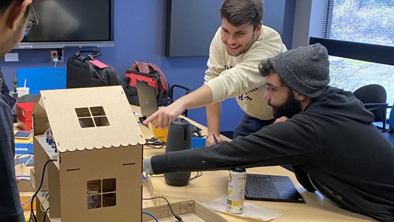 Students in a conference room working on a project